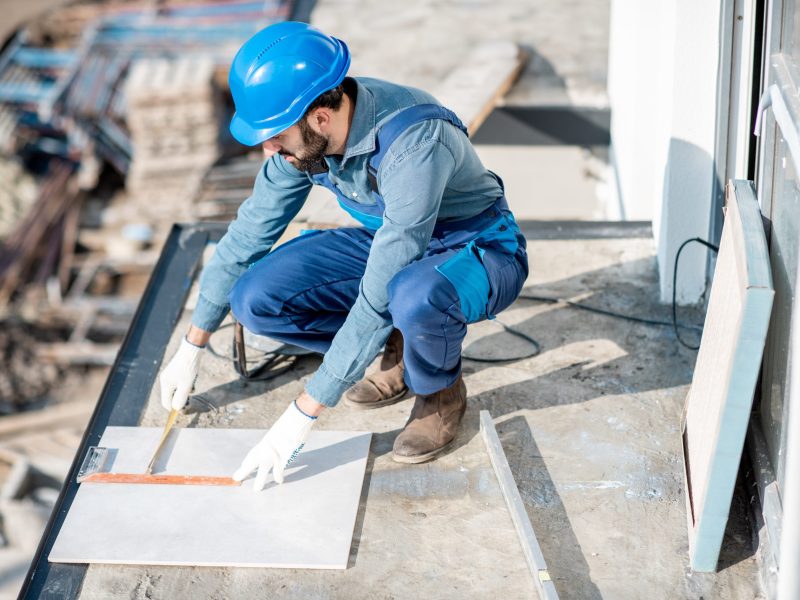 workman-laying-tiles-on-the-balcony-2025-03-15-06-05-21-utc